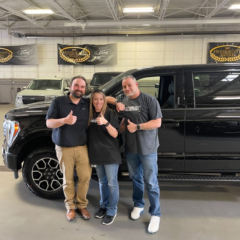 Customers in Front of 2024 F-150 Hybrid from Bill Brown Ford Near Metro Detriot